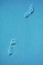 Surreal Pop art styled woman`s walking footprints on the sand beach in blue color Royalty Free Stock Photo