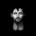 surreal portrait of a man covering his face and eyes with his hands, face shines through hands, double exposure, psychological Royalty Free Stock Photo