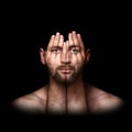 surreal portrait of a man covering his face and eyes with his hands, face shines through hands, double exposure, psychological Royalty Free Stock Photo