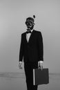 Surreal portrait of a man a secret agent spy in a suit and a diving mask and snorkel with a suitcase in his hand Royalty Free Stock Photo