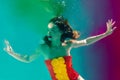 Surreal portrait of young attractive woman with air bubbles underwater in colorful water with ink Royalty Free Stock Photo