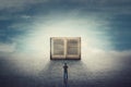 Surreal scene as student guy stands on a pavement road in front of a giant opened book. The importance of reading and literature Royalty Free Stock Photo