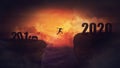 Surreal scene, man jump over a chasm obstacle between 2019 and 2020 years. Self overcome, starting a new year. Way to win and Royalty Free Stock Photo