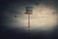 Surreal scene, tiny man stands in front of a huge signpost with three different directions. Choosing the correct way to unknown Royalty Free Stock Photo