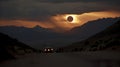 Surreal solar eclipse at sunset over mountains. Mystical eclipse illustration over a desert mountain range. Royalty Free Stock Photo