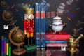Surreal still life with nutcracker, books, globe, and golden objects Royalty Free Stock Photo