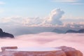 Surreal stone podium outdoors on clouds in soft blue sky pink pastel misty mountain nature landscape.