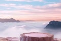 Surreal stone podium outdoors on clouds in soft blue sky pink pastel misty mountain nature landscape.