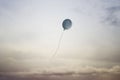 Surreal travel of a balloon flying in the sky towards freedom, concept of lightness of the spirit of dreamers