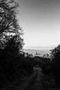 Surreal and uncommon view of St.Francis church in Assisi town Umbria over a sea of fog, at the end of a road in the Royalty Free Stock Photo