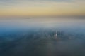 Surreal view of church almost completely hidden by fog