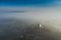 Surreal view of church almost completely hidden by fog