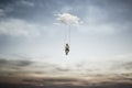 Surreal woman having fun on a swing hanging from a cloud, abstract concept