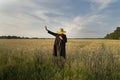 Surreal woman - scarecrow stands in weath cereal field. Royalty Free Stock Photo