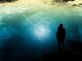 Surrealism landscape, surrealism planet, ocean and glacier landscape with an airplane flying over it and a hiker watching it. Royalty Free Stock Photo