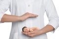 Surrogacy concept. Doctor holding adorable newborn baby on white background, closeup