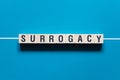 Surrogacy word concept on cubes