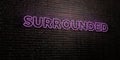 SURROUNDED -Realistic Neon Sign on Brick Wall background - 3D rendered royalty free stock image