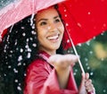 Surrounded by showers of blessings. a beautiful young woman standing in the rain with an umbrella. Royalty Free Stock Photo