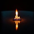 The surrounding area is dimly lit, emphasizing the flame\'s brightness Royalty Free Stock Photo
