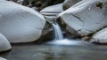 The surrounding rocks frame the cascade highlighting the seamless flow of Royalty Free Stock Photo
