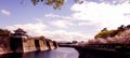 The surroundings of Osaka Castle in spring season with beautiful sky, calm river and cherry blossom Royalty Free Stock Photo