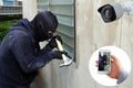 Surveillance Camera capture and record caught Masked thief with hammer and hand holding Mobile Phone Detecting on application Royalty Free Stock Photo