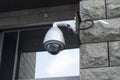 A surveillance camera on a city street monitors passers-by and recognizes faces