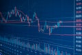 Stock market chart with red zigzag line, suggesting bullish trend on blue background Royalty Free Stock Photo