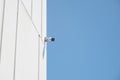 Surveillance Camera Mounted on Building Against Clear Blue Sky Royalty Free Stock Photo