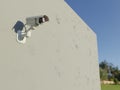 Surveillance camera mounted on an exterior wall. Video surveillance in public places. Digital 3D rendering