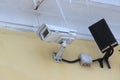 Surveillance camera mounted on tiled wall of house