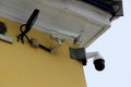 Surveillance camera mounted on tiled wall of house