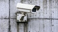 Surveillance camera mounted on a weathered concrete wall Royalty Free Stock Photo