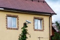 Surveillance camera near the country house. Security camera against the wall of the house Royalty Free Stock Photo