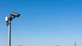 Surveillance camera on pole against clear blue sky Royalty Free Stock Photo