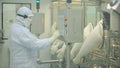 Pharmaceutical Production Line Worker at Work. Robotic arm lifting ampules at packaging line in pharmaceutical factory