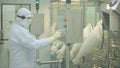 Pharmaceutical Production Line Worker at Work. Robotic arm lifting ampules at packaging line in pharmaceutical factory