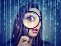 Surveillance of cyber crime concept. Curious woman looking through a magnifying glass and computer binary code background