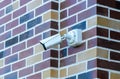 Surveillance video camera to wall outside building for security. CCTV camera on wall of building. Royalty Free Stock Photo