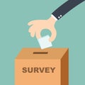 Survey concept - hand putting voting paper in the ballot box