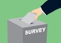 Survey concept - hand putting voting paper in the ballot box