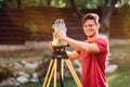 survey engineer in garden elevation using and working with theodolite Royalty Free Stock Photo