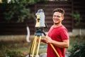 Survey engineer using and working with total station theodolite at landscaping project Royalty Free Stock Photo