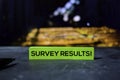 Survey Results! on the sticky notes with bokeh background