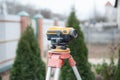 Surveying measuring equipment level transit on tripod at construction building area site Royalty Free Stock Photo