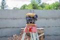 Surveying measuring equipment level transit on tripod at construction building area site Royalty Free Stock Photo