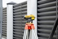 Surveying measuring equipment level transit on tripod at construction building area site Royalty Free Stock Photo