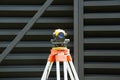 Surveying measuring equipment level transit on tripod at construction building area site Royalty Free Stock Photo