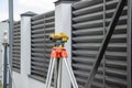 Surveying measuring equipment level transit on tripod at construction building area site Royalty Free Stock Photo